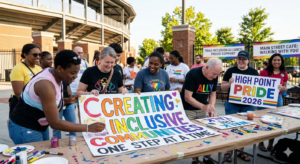 crowd making pride signs